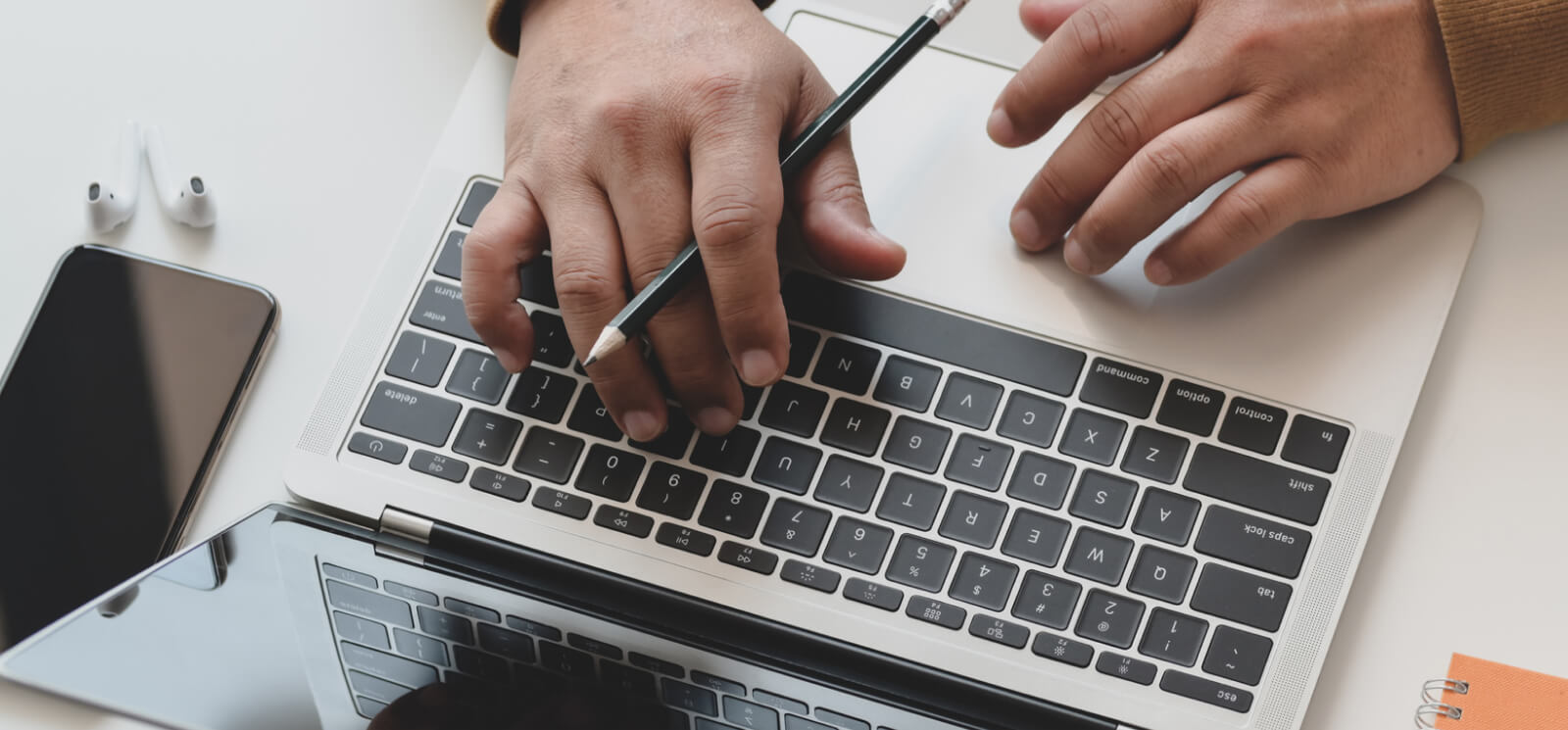 hands typing on laptop