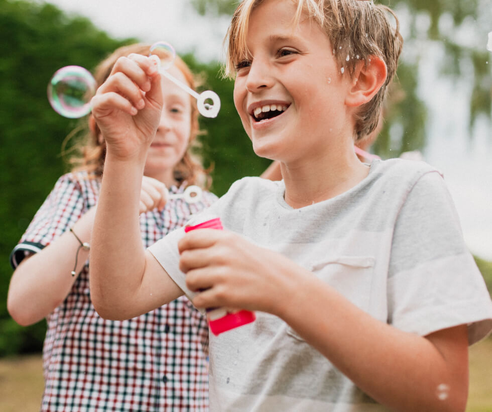 Young kids playing with bubbles